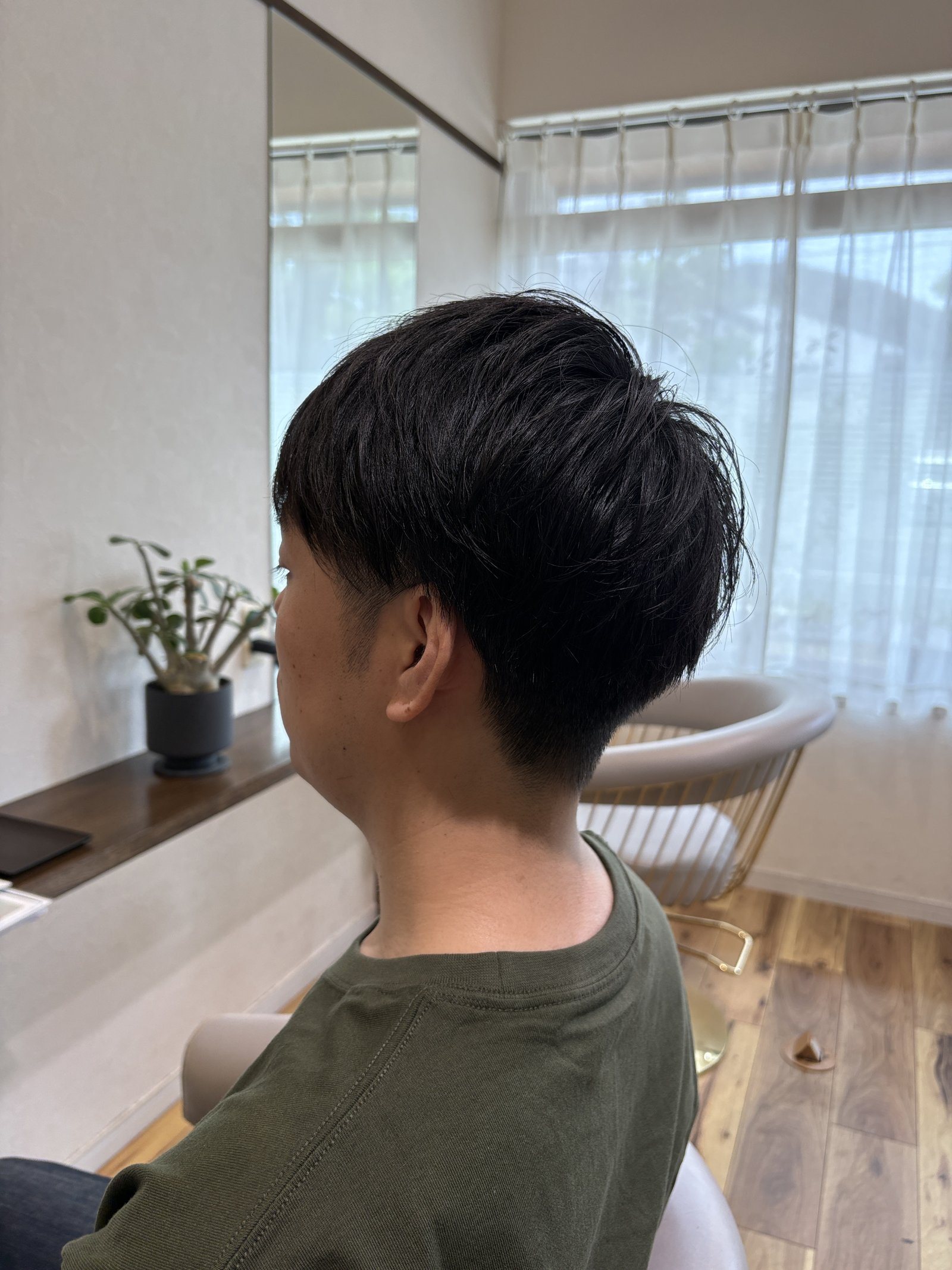 サイドから襟足へ自然につながる刈り上げのグラデーション、斜め後ろ